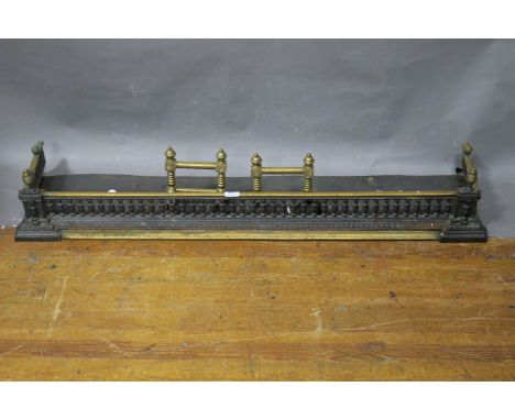 A METAL AND BRASS MOUNTED FENDER, together with a pair of and-irons ensuite, of typical form with a bobbin turned gallery on 