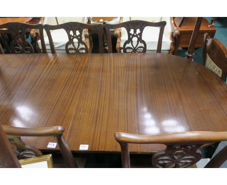 A REGENCY STYLE MAHOGANY DINING TABLE the rectangular top with rounded ends and one loose leaf on twin tripod supports  75cm 