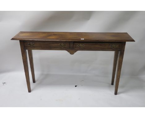 A MAHOGANY CROSSBANDED CONSOLE TABLE the rectangular top with moulded rim above two frieze drawers with shaped apron on taper