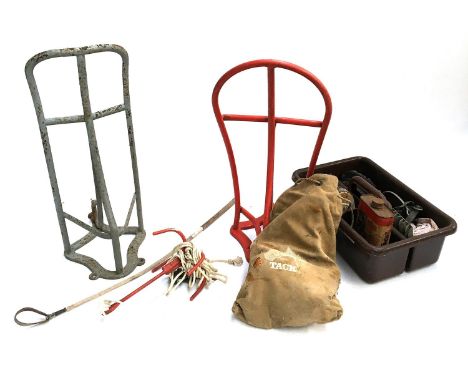 Two saddle racks and one bridle holder, together with a whip, vintage grooming kit, an English hunting saddle, bears label So