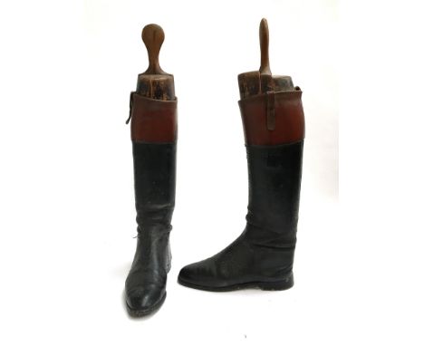 A pair of gent's black leather hunting boots with mahogany tops, and wooden trees 