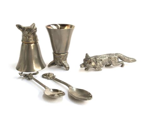A pair of fox mask stirrup cups, each approximately 8cm high; together with two teaspoons, one with leaping fox terminal, the