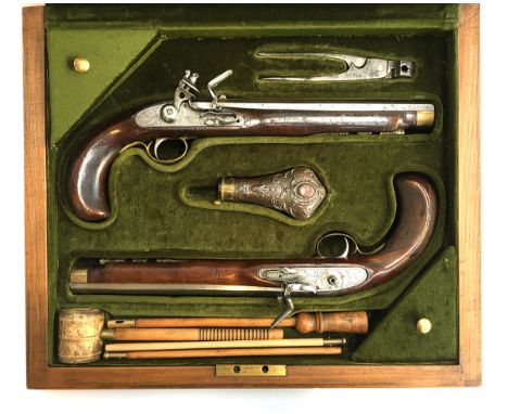 A pair of replica flintlock duelling pistols, silvered finish, one with hammer missing, in later fitted case, with powder fla