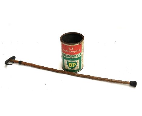 A vintage BP tin, together with an unusual walking stick 