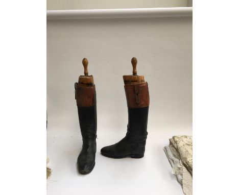 A pair of gent's black leather hunting boots with mahogany tops, patch repairs, approx. size 9.5, with wooden trees 