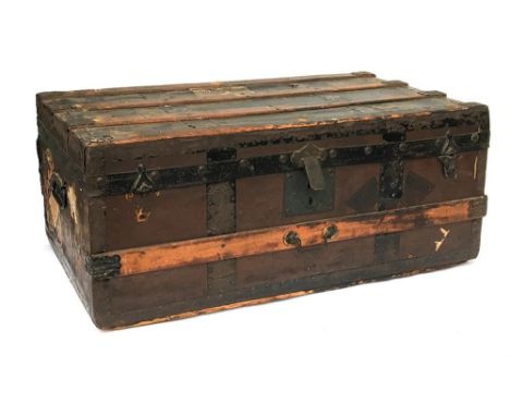 A wood banded travel trunk with metal brackets, with various travel labels, including Jerusalem, Palestine, 77cmW 