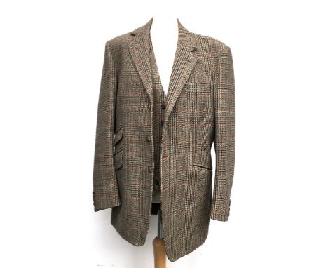 A gent's three piece tweed suit, tailored by Moss Bros., 1983, the jacket with double vent to rear and ticket pocket; the tro