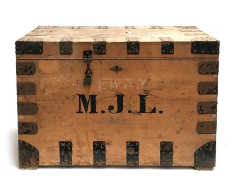 A pine travel chest with metal bracing and loop handles, bears label 'M. Cleghorn, Edinburgh, portmanteau and trunk manufactu