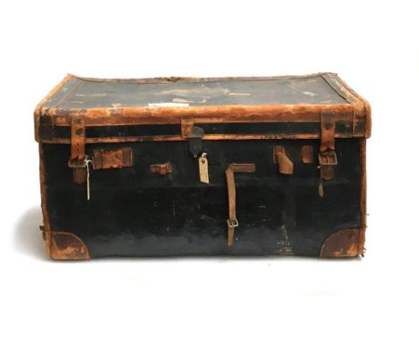 An early 20th century leather and canvas travel trunk with London &amp; South Western railway stickers, the side marked LIE, 