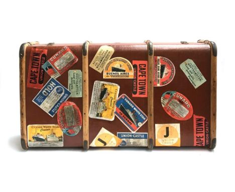 A vintage travel trunk with beechwood banding and metal brackets, various travel stickers, 92x50x28cm 