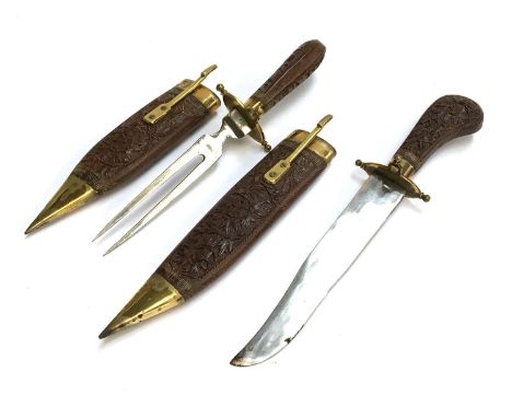 A hardwood and brass carving set comprising knife and fork, each with sheath 