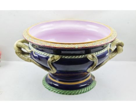 A "MINTON" MAJOLICA GLAZED POTTERY JARDINIERE of shallow urn form, having cobalt blue glazed exterior with entwined serpent h