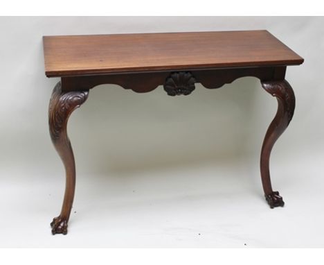 A GEORGIAN DESIGN MAHOGANY CONSOLE TABLE, raised on cabriole fore supports with acanthus leaf carving, and ball and claw feet