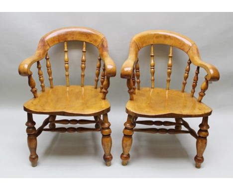 A PAIR OF EDWARDIAN SPOON BACK LIBRARY CHAIRS with scroll terminal arms, turned spindle backs, shaped possibly elm seats, on 