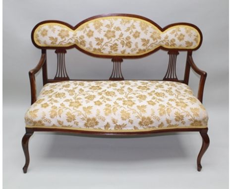 AN EDWARDIAN STAINED BEECH FRAMED OPEN ARM TWO-SEATER SOFA, having cream and gold floral fabric upholstered seat and back pad