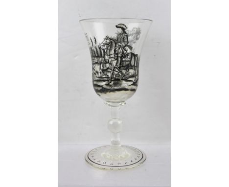 A 19TH CENTURY CONTINENTAL WINE GLASS, the bell form bowl black painted in the round with an 18th century hunting scene, rais