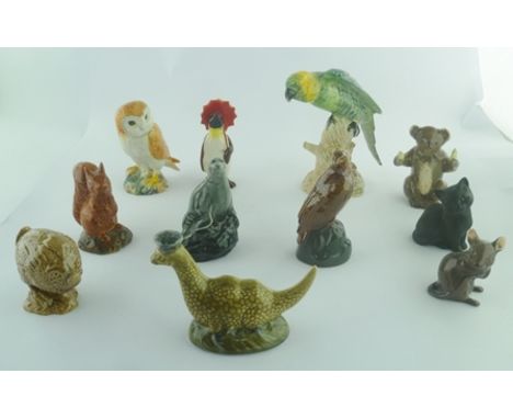 A COLLECTION OF BESWICK CERAMIC FIGURES comprising; parrot perched on a stump no.930, penguin with red umbrella, owl no.2026,