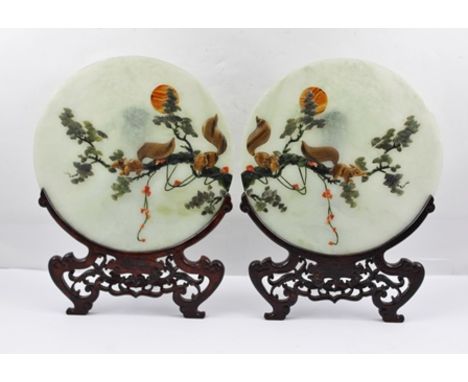 A PAIR OF CHINESE JADE ROUNDELS, inset with hardstone decoration, squirrels upon tree branches, 27cm diameter, complete with 
