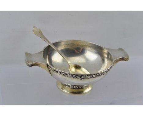 WILLIAM DAVENPORT  A CELTIC DESIGN SILVER PORRINGER, fitted with a pair of lug handles, decoratively banded, raised on domed 