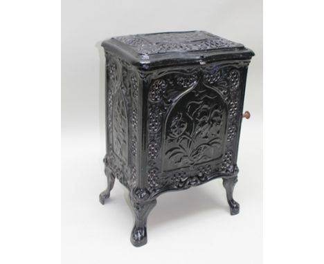 AN EARLY 20TH CENTURY DECORATIVE BLACK ENAMEL FINISHED CAST IRON WOOD BURNING STOVE, raised on cabriole feet, 40cm wide x 62c
