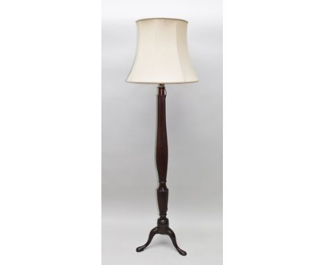 A STANDARD LAMP FORMED FROM A GEORGE III MAHOGANY BED POST, of reeded, on tripod supports, on tripod supports with cream fabr