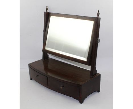 A 19TH MAHOGANY SWING TOILET MIRROR having reeded supports with brass finials, the box base fitted with two drawers, raised o