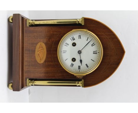 AN EDWARDIAN MAHOGANY CASED MANTEL CLOCK, the lancet form case with brass columns and shell patera, fitted an enamel dial wit