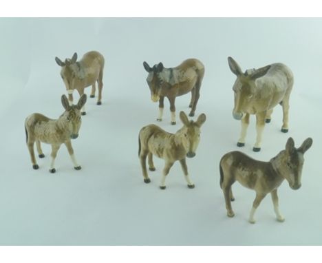 A COLLECTION OF BESWICK CERAMIC FIGURES comprising; three donkeys and three donkey foals (6) 