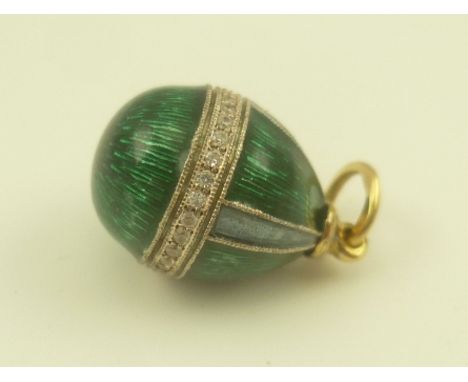 A RUSSIAN OVOID FORM CHARM PENDANT having green guilloche enamel with a band of diamonds, suspension ring bears various assay