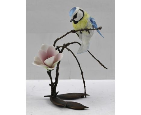 ALBANY (Worcester) A porcelain figure of a Blue Tit modelled on a bronzed branch over almond blossom, impressed "Albany" 