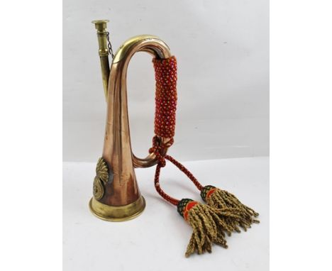 A COPPER AND BRASS BUGLE, bears "Royal Welsh Fusiliers" crest, fitted bound tasselled cord, 29cm 