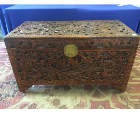 Large Chinese Carved Camphor Wood Trunk, top extensively carved with central fan shaped panel of Chinese junks at sea surroun