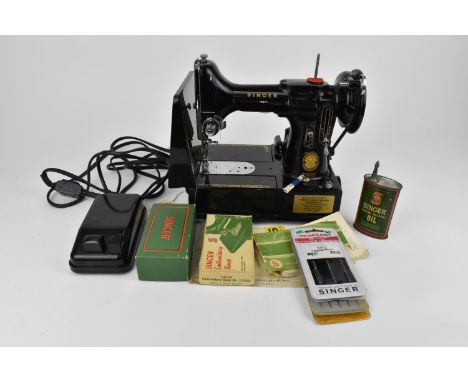 A Singer Featherweight portable sewing machine, model 222K in compact black case with instruction leaflet and extra bobbins, 