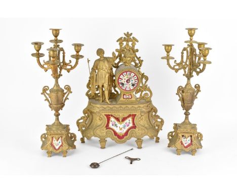 A early 20th century three piece spelter and porcelain mantel clock set. Comprising, a central mantel clock with painted porc