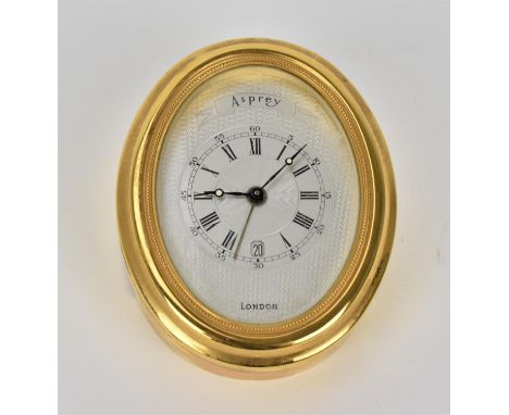 An Asprey gilt brass alarm desk clock, having a machine turned dial, Roman numerals, luminous markers and date aperture at 6,