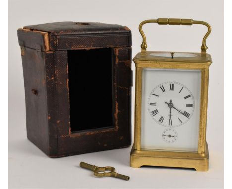 An early 20th century brass cased alarm and repeating carriage clock having a white enamelled dial with Roman numerals and su