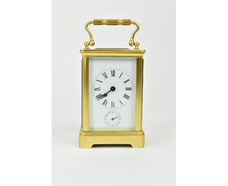 A brass cased carriage clock with alarm. Having a white enamel dial with Roman numerals and Arabic subsidiary seconds dial. A