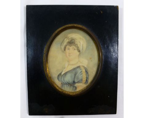 An early 19th century oval portrait miniature on ivory of a young woman, wearing a blue dress, 8.8cm x 7cm, house in gilt met