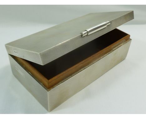 An Art Deco style silver cigarette box with cedar lining and engine turned decoration, Birmingham 1968, 16.7cm x 8.6cm x 5.1c