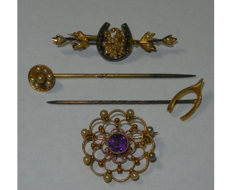 An Edwardian amethyst and seed pearl openwork brooch, 24mm diameter, a gold half pearl set horseshoe bar brooch, 43mm long, c