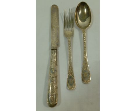 A Victorian three piece silver christening set comprised of a knife, fork and spoon, ornately chased with foliage, London 188