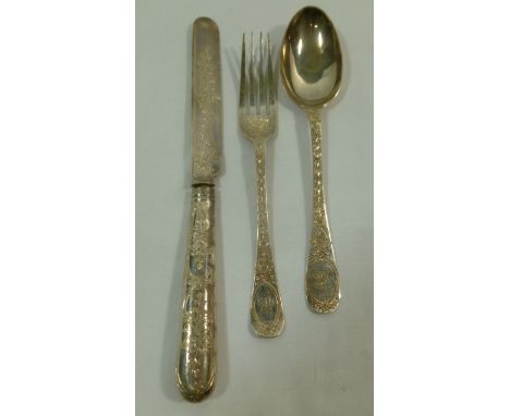 A Victorian three piece silver christening set comprised of a knife, fork and spoon, ornately chased with foliage, London 188