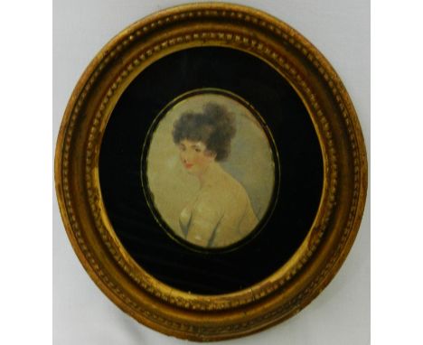 A small 18th century oval hand coloured stipple engraving of a portrait of a woman, 8cm x 6.5cm, in églomisé mount and oval g
