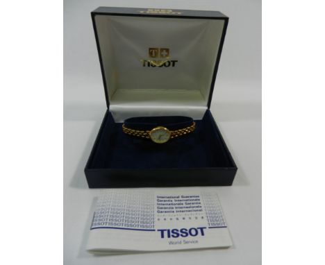 A ladies 9 carat gold Tissot bracelet watch, the case and strap stamped '375', the oval face with baton numerals, 19g gross, 