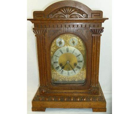 An Edwardian oak cased mantle clock, with three-train movement striking on a gong and four gongs, width 31 cm, height 45 cm C