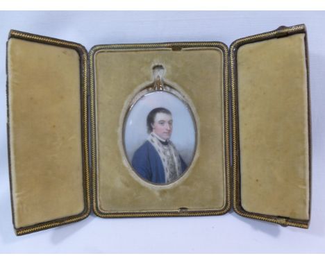 An 18th century oval portrait miniature of a gentleman, in ermine trimmed coat,  housed in a gold frame with hair panel to th
