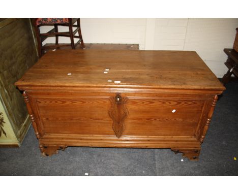 A 19th century Iberian pine coffer, with turned pilasters at the corners and applied moulded detail, raised on on shaped brac