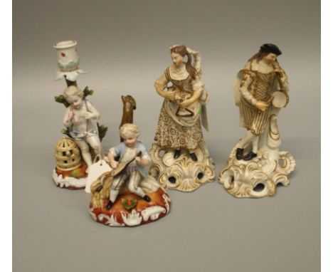 A pair of early 19th century Continental porcelain figures of musicians, a German porcelain figure of a child harvester with 
