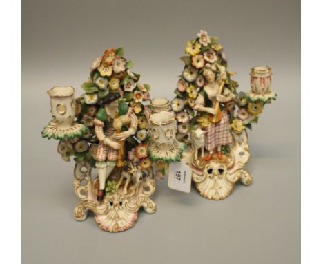 A pair of 18th century Derby two sconce table candlesticks modelled with a piper and female companion playing a lute, each wi