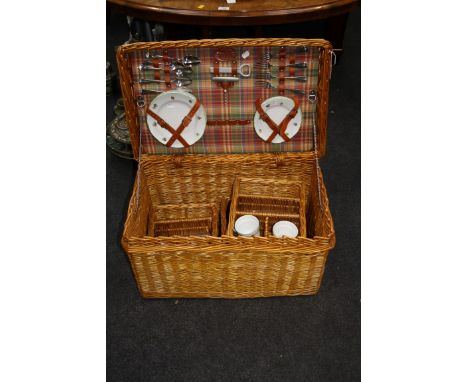 A vintage Harrod's of Knightsbridge wicker picnic set, with plates, cups, saucers, cutlery, etc, 72cm wide